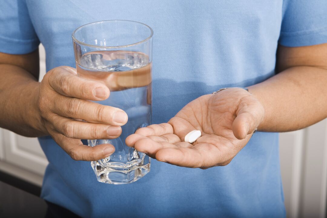 a man drinking a parasite pill